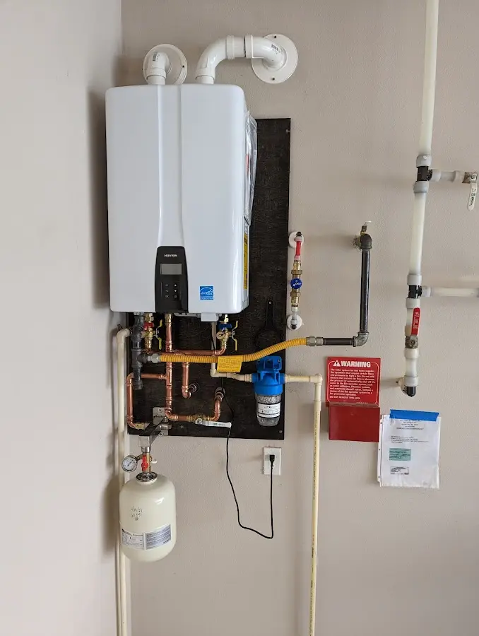 Professional plumber installing copper piping in a Lone Grove home